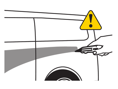 A hand lifts the softened film edge beside a yellow caution symbol.